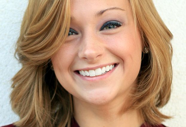 Smiling girl with blond hair and blue eyeshadow