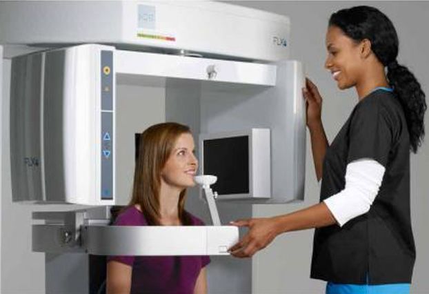 Woman having panoramic x-ray taken of her mouth
